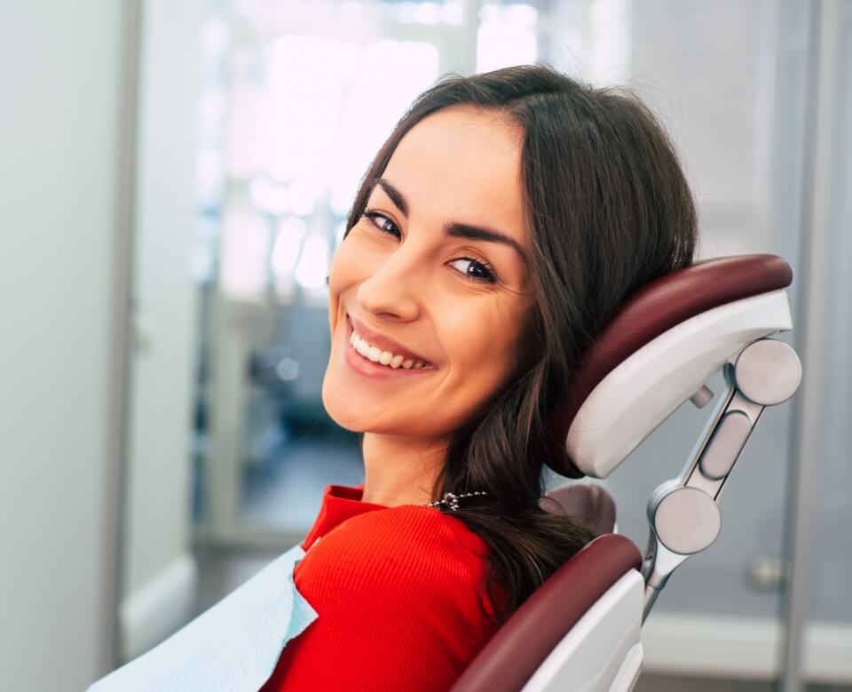 Woman smiling during dental treatment visit