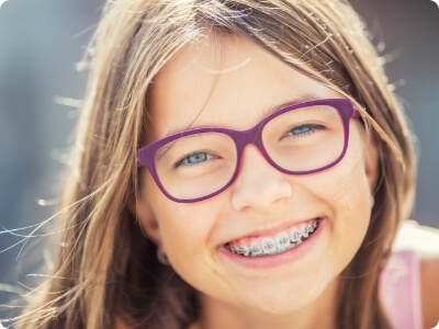Smiling preteen with self ligating braces
