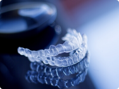 Set of Invisalign clear aligners on tabletop