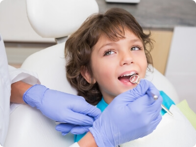 Young dentistry patient receiving children's dental checkups and teeth cleanings