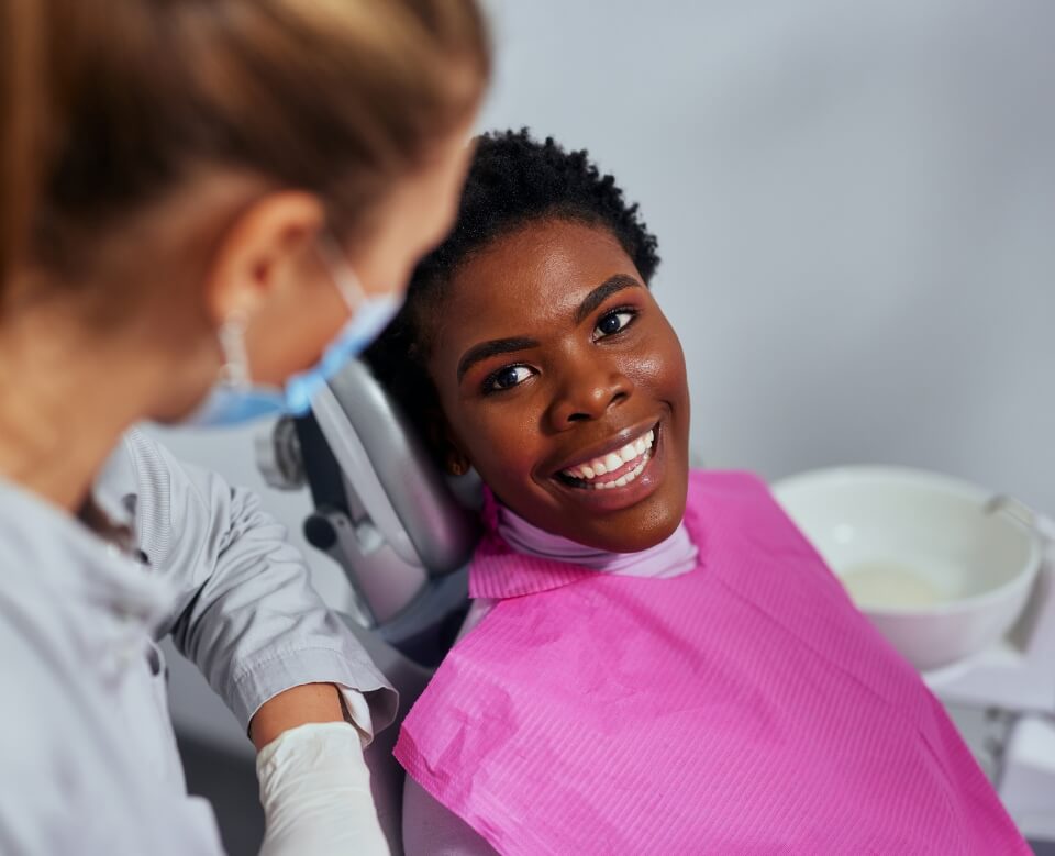 Woman smiling at dentist after dental services